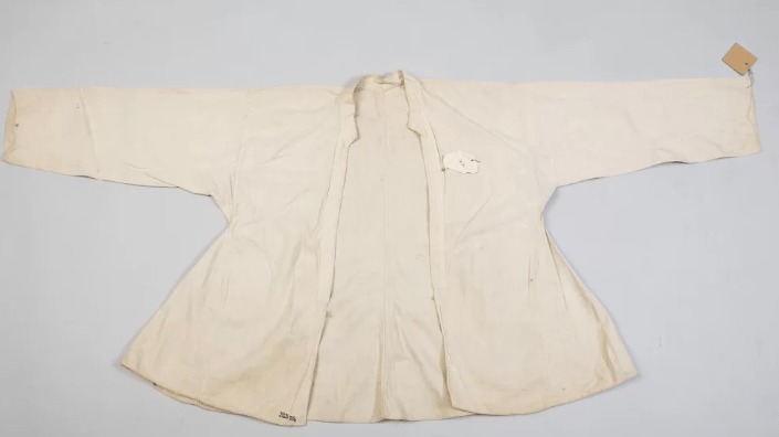 Valkoinen koristelematon naisen kostuli.